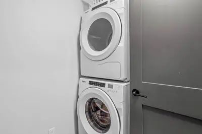 a washer and a washing machine in a room at Creekside Cove in Spring Creek in Canmore