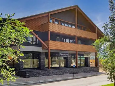a large wooden building with at Creekside Cove in Spring Creek in Canmore