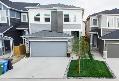 a house with a garage in the driveway at Cozy Luxe Suites in Calgary