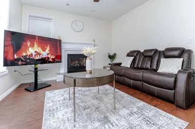 a living room with a couch and a fireplace at Northern Solace, 2 beds, 2 baths, 5 min to airport in Yellowknife