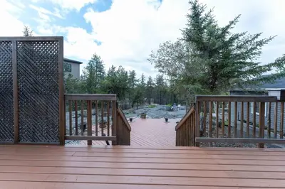 a large wooden deck with two benches on it at Northern Solace, 2 beds, 2 baths, 5 min to airport in Yellowknife