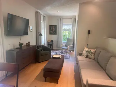 a living room with a couch and a flat screen tv at Lake Trail Guesthouse in Victoria