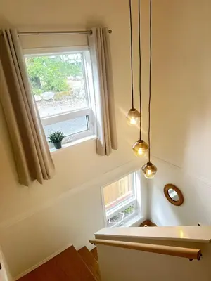 a kitchen with a window and two lights at Lake Trail Guesthouse in Victoria