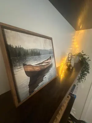 a painting of a boat on a table with lights at Lake Trail Guesthouse in Victoria