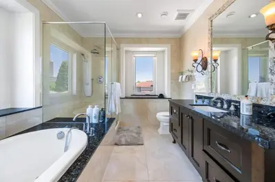 a large bathroom with a tub and a sink at Luxury 4-Bedroom Villa in Vancouver