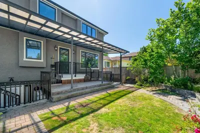 a home with a patio and a fence at Luxury 4-Bedroom Villa in Vancouver
