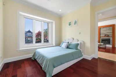 a bedroom with a large bed and a window at Luxury 4-Bedroom Villa in Vancouver
