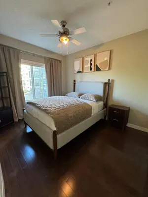 a bedroom with a bed and a ceiling fan at Peaceful Condo for Short and Long Term Rental in Edmonton