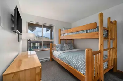 a bedroom with two bunk beds and a desk at 2BR in Symphony, Hot Tub, Gas Fireplace, Epic Village Location, Ski Shuttle in Whistler
