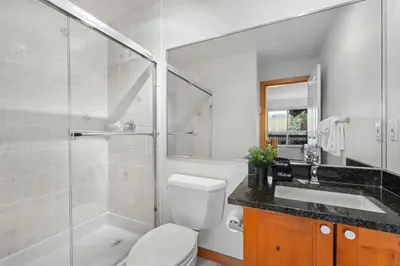 a bathroom with a toilet and a sink and a shower at 2BR in Symphony, Hot Tub, Gas Fireplace, Epic Village Location, Ski Shuttle in Whistler