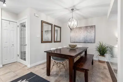 a dining room with a wooden table and chairs at 1BR and Sofabed in The Gables, Epic Village Location, Secure Parking, Forest Views in Whistler