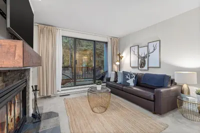 a living room with a couch and a fireplace at 1BR and Sofabed in The Gables, Epic Village Location, Secure Parking, Forest Views in Whistler