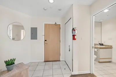 a bathroom with a toilet and a wooden door at 2BR in Ironwood, Stunning Mountain Views, Shared Hot Tub and Pool, Fireplace, Parking in Whistler