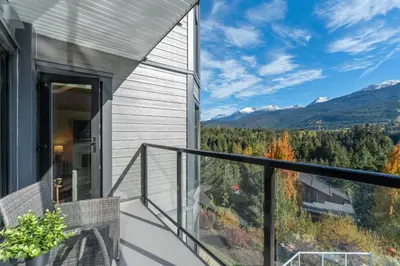 a balcony with a view of the mountains at 2BR in Ironwood, Stunning Mountain Views, Shared Hot Tub and Pool, Fireplace, Parking in Whistler