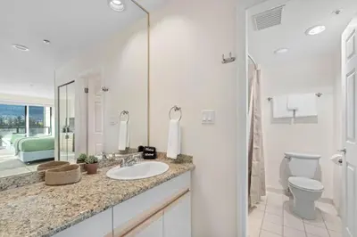 a white bathroom with a sink and a toilet at 2BR in Ironwood, Stunning Mountain Views, Shared Hot Tub and Pool, Fireplace, Parking in Whistler