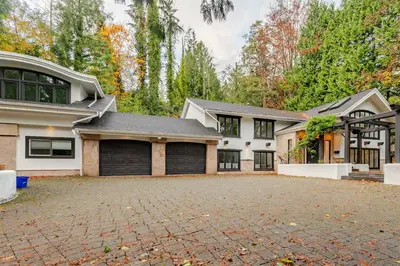a large white house with a driveway at Serene 5-Bedroom Nature Retreat in West Vancouver