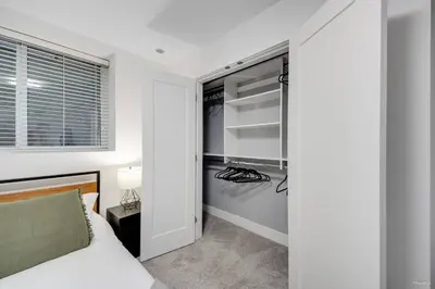 a bedroom with a bed and a closet at Modern 2Bed Suite Near Capilano Bridge & Trails in North Vancouver