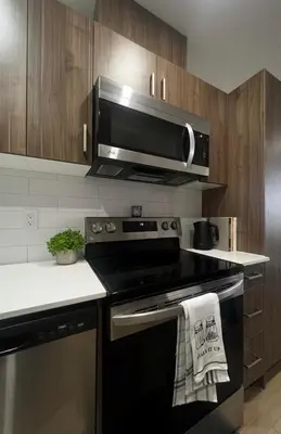 a kitchen with a black stove and a microwave at Apartment in Downtown YEG in Edmonton