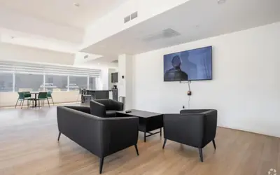 a living room with black chairs and a table at Apartment in Downtown YEG in Edmonton