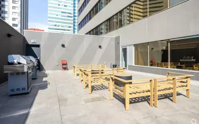 a group of wooden benches sitting outside of a building at Apartment in Downtown YEG in Edmonton