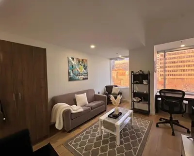 a living room with a couch and a table at Apartment in Downtown YEG in Edmonton