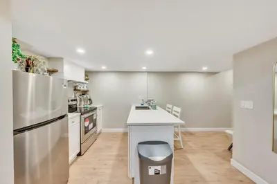 a kitchen with white appliances and a white counter top at Spacious 3 BDR Suite Sleeps 6 Comfortably in Edmonton