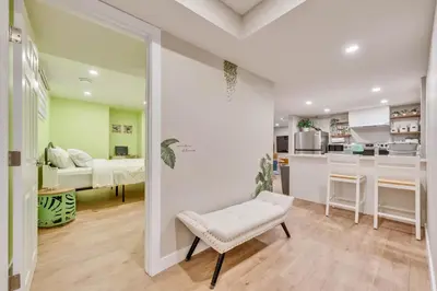 a living room with a bench and a bedroom at Spacious 3 BDR Suite Sleeps 6 Comfortably in Edmonton