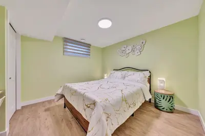a bedroom with a large bed in a room at Spacious 3 BDR Suite Sleeps 6 Comfortably in Edmonton
