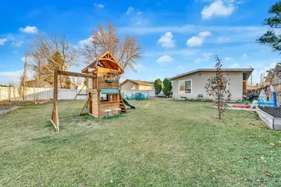 a playground in a yard with a house at Spacious 3 BDR Suite Sleeps 6 Comfortably in Edmonton