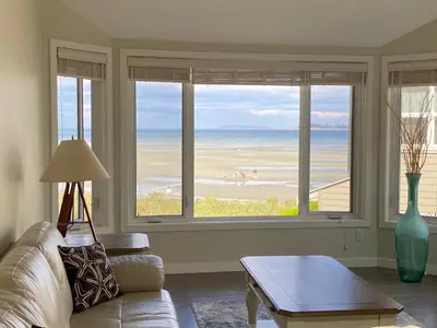 a living room with a couch and a view of the ocean at Tanglewood 13 in Parksville