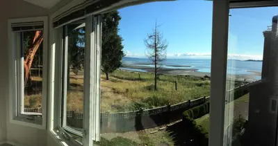 a window view of the ocean from a house at Tanglewood 13 in Parksville