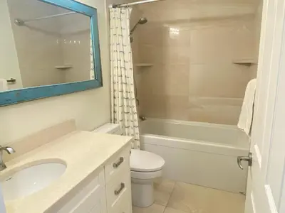 a bathroom with a sink and a toilet and a tub at Tanglewood 13 in Parksville