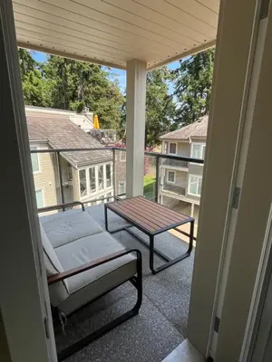 a porch with a bed and a table on a balcony at Tanglewood 18 in Parksville