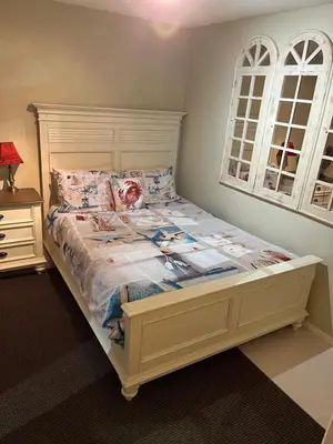 a bedroom with a bed with a white bed frame at Tanglewood 18 in Parksville