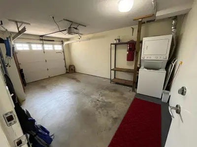 an empty garage with a refrigerator and a stove at Tanglewood 18 in Parksville
