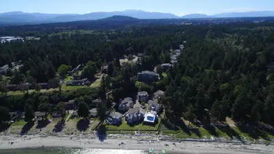 an aerial view of a large house in the forest at Tanglewood 18 in Parksville