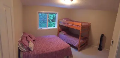 a small bedroom with a bunk bed and a window at Tanglewood 19 in Parksville