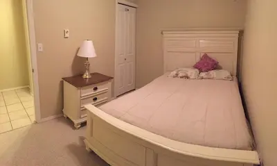 a bedroom with a large bed and a lamp on a night stand at Tanglewood 19 in Parksville
