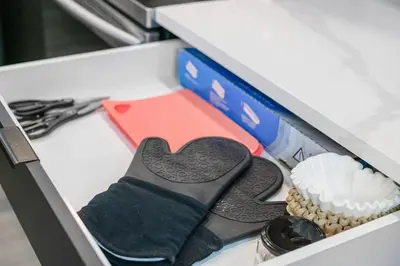 a drawer with a pair of gloves and a cupcake at WEM Retreat | 3BR | Mins from the Mall in Edmonton