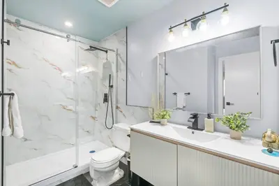 a bathroom with a shower and a toilet and a sink at WEM Retreat | 3BR | Mins from the Mall in Edmonton