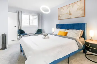a bedroom with a large bed with a cat toy on it at WEM Retreat | 3BR | Mins from the Mall in Edmonton