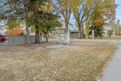 a sign sitting in the grass next to a street at WEM Retreat | 3BR | Mins from the Mall in Edmonton