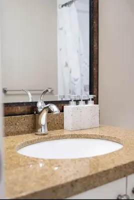 a bathroom counter with a sink and a mirror at Stylish Home in Van West Side Near YVR&DT in Vancouver