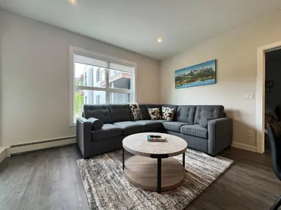 a living room with a couch and a table at Paradise Point - Hot Tub & Mountain Views in Golden
