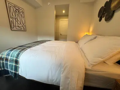 a bedroom with a large white bed in a room at Paradise Point - Hot Tub & Mountain Views in Golden