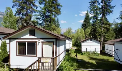 a tiny house in a yard with trees at Mountain View Cabins in Golden