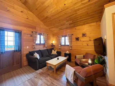 a living room with a couch and a table at Radium Cabins Centrally located in Radium Hot Springs BC in Radium Hot Springs