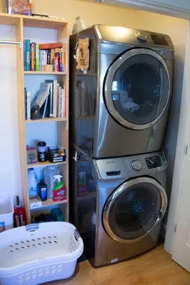 a television and a washing machine in a room at Cozy modern floating home next to Lonsdale Quay in North Vancouver