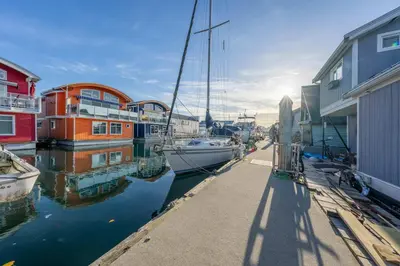 a group of boats are docked in a marina at Cozy modern floating home next to Lonsdale Quay in North Vancouver