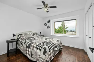 a bedroom with a bed and a window at Kelowna full level luxury-BIG white ski 35 mins in Kelowna